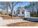 Modern farmhouse style home exterior, showcasing a two-car garage and side yard at 3779 Churchill Sw Dr, Marietta, GA 30064