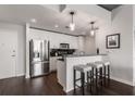 Modern white kitchen with stainless steel appliances and breakfast bar at 860 Peachtree Ne St # 2605, Atlanta, GA 30308