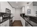 Modern galley kitchen with stainless steel appliances and dark countertops at 860 Peachtree Ne St # 2605, Atlanta, GA 30308