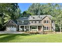 Two-story home with stone accents and a beautifully landscaped lawn at 4152 Club Dr, Atlanta, GA 30319