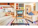 Living room with eclectic decor, hardwood floors, and built-in shelving at 1576 Temple Ave, Atlanta, GA 30337