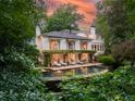 Inviting pool and patio area, surrounded by lush greenery at 1020 W Wesley Nw Rd, Atlanta, GA 30327