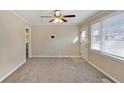 Bright living room featuring neutral walls, new carpet, and ceiling fan at 1761 Derrill Dr, Decatur, GA 30032