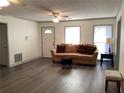 Cozy living room featuring neutral paint, plush couch, and vinyl flooring at 35 Fairfield Dr, Ellenwood, GA 30294