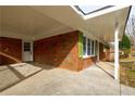 Covered porch with brick columns and concrete flooring at 5310 Timbo Ln, Mableton, GA 30126