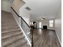 View of a carpeted staircase leading to an open living area with hardwood floors at 6543 Woodwell Dr, Union City, GA 30291