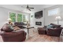 Spacious living room with a fireplace and leather furniture at 667 Crosshaven Dr, Marietta, GA 30066