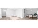 Open living and dining space with grey walls, modern light fixtures and light wood floors at 3091 Colonial Way # E4, Chamblee, GA 30341