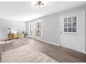 Open concept living room boasts lots of natural light from the sliding glass door at 3091 Colonial Way # E4, Chamblee, GA 30341