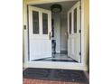 Elegant entryway with double doors, a chandelier, and a black and white tiled floor at 1417 Doe Valley Dr, Lithonia, GA 30058