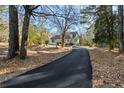 Curving driveway to charming house nestled among mature trees at 3133 Callie Still Rd, Lawrenceville, GA 30045