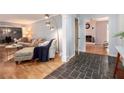 Open living space with hardwood floors and cozy seating area at 5513 N Peachtree Rd, Dunwoody, GA 30338