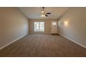 Bright living room featuring a large window and ceiling fan at 100 Glace Rd, Atlanta, GA 30349