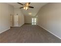 Spacious living room with vaulted ceilings and neutral carpeting at 100 Glace Rd, Atlanta, GA 30349