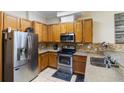 Kitchen with stainless steel appliances and light wood cabinets at 4892 Pinnacle Dr, Stone Mountain, GA 30088