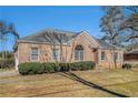 Brick ranch house with a landscaped lawn and mature trees at 3542 Linecrest Rd, Ellenwood, GA 30294