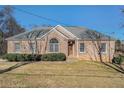 Brick ranch house with a landscaped lawn and mature trees at 3542 Linecrest Rd, Ellenwood, GA 30294