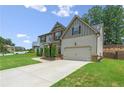House exterior showcasing landscaping and driveway at 6235 Stillwood Ln, Cumming, GA 30041
