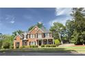 A traditional brick home with a manicured lawn and mature landscaping in a suburban neighborhood at 2968 Winterthur Close Nw, Kennesaw, GA 30144