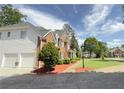 Two-story brick home with a landscaped yard and decorative arch at 2968 Winterthur Close Nw, Kennesaw, GA 30144