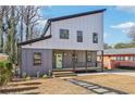 Modern two-story house with gray and white siding, a light green door, and a stone path at 665 Ferris Sw St, Atlanta, GA 30310