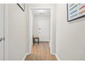 Light-filled hallway with hardwood floors and access to other rooms at 1660 Cedar Bluff Way, Marietta, GA 30062