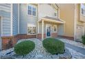 Two-story townhome with blue door and landscaped front yard at 3284 Long Iron Pl, Lawrenceville, GA 30044