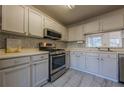 Modern kitchen with stainless steel appliances and light grey cabinets at 3284 Long Iron Pl, Lawrenceville, GA 30044