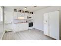 Kitchen with white cabinets, vinyl flooring, and appliances at 24 Echo Ridge Dr, Powder Springs, GA 30127