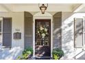 Elegant front door with a wreath and sidelights at 566 Church Ne St, Marietta, GA 30060