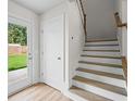 Modern staircase with wooden steps and white risers at 2425 Valient Dr, Cumming, GA 30041