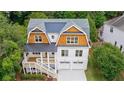 Aerial view of home with lush green surroundings, shingle accents, and a two-car garage at 2717 Skyland Dr, Brookhaven, GA 30319