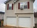 Two-car garage with white doors, attached to the house at 5374 Shirewick Ln, Lithonia, GA 30058