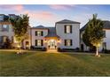 Stunning two-story home with a metal roof and charming landscaping at 211 N Esplanade, Alpharetta, GA 30009