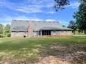 Brick home's back view, featuring a screened porch at 130 Fiddle Crk, Social Circle, GA 30025