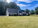 Ranch home with a spacious yard, showcasing its side at 130 Fiddle Crk, Social Circle, GA 30025
