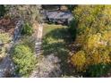 An aerial view of a charming home with a large, well-manicured front lawn surrounded by mature trees at 1141 Goodwin Ne Pl, Brookhaven, GA 30319