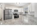 Kitchen boasts granite countertops and stainless steel appliances at 1884 Martin Sw Rd, Marietta, GA 30008