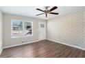 Living room features wood-look floors and a brick accent wall at 1884 Martin Sw Rd, Marietta, GA 30008