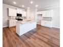 Modern kitchen with granite countertops, a large island, stainless steel appliances, and ample cabinet space at 4090 Cavalier Way, Duluth, GA 30097