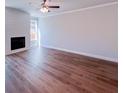 Bright living room featuring a cozy fireplace with shiplap accent wall and gleaming hardwood floors at 4090 Cavalier Way, Duluth, GA 30097