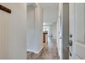 Inviting hallway with wood floors and a view into the open-concept living area at 1965 Nocturne Dr # 1209, Alpharetta, GA 30009