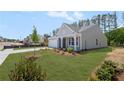 Side view of a gray single-story home with a well-kept lawn and a light-colored driveway at 106 Cherry Glen Way, Euharlee, GA 30145