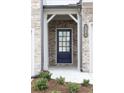 Blue front door with glass panes and a brick facade at 1395 Ben Park Way, Grayson, GA 30017