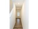 Hallway with wood-look floors and door to the garage at 1395 Ben Park Way, Grayson, GA 30017