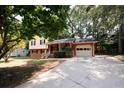 Ranch home with driveway, mature trees, and a well-maintained lawn at 500 Carillon Ct, Stone Mountain, GA 30083
