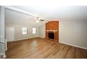 Living room featuring hardwood floors and a brick fireplace at 500 Carillon Ct, Stone Mountain, GA 30083