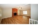 Spacious living area with brick fireplace and laminate flooring at 500 Carillon Ct, Stone Mountain, GA 30083