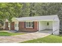 Ranch house with carport and mature trees in front at 895 Kings Grant Nw Dr, Atlanta, GA 30318