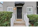 Front entrance with black door, white railings, and landscaping at 285 Oxford Ne Pl # 4, Atlanta, GA 30307